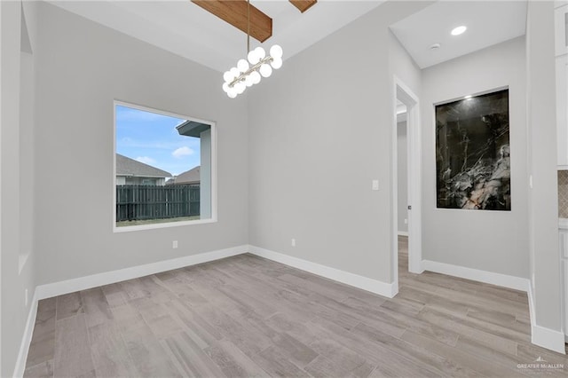 1809 W Hayes Ave, Alton, TX 78573 - unfurnished room featuring light wood finished floors, a chandelier, and baseboards