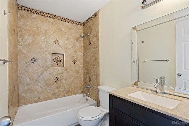 full bathroom featuring tiled shower / bath combo, vanity, and toilet