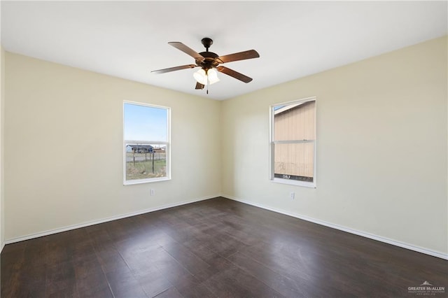 spare room with ceiling fan and dark hardwood / wood-style flooring