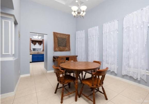 tiled dining room featuring a notable chandelier