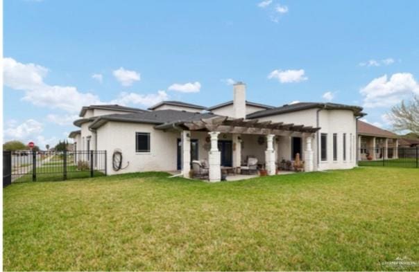 rear view of house with a pergola and a lawn