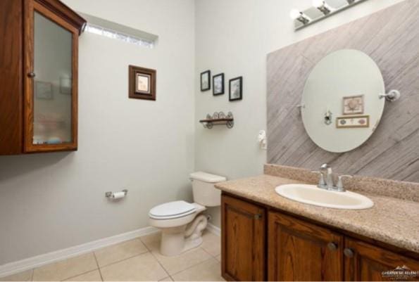 bathroom featuring toilet, vanity, and tile patterned floors