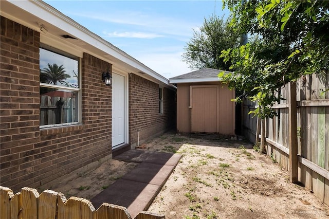 view of yard with a shed, an outdoor structure, and a fenced backyard