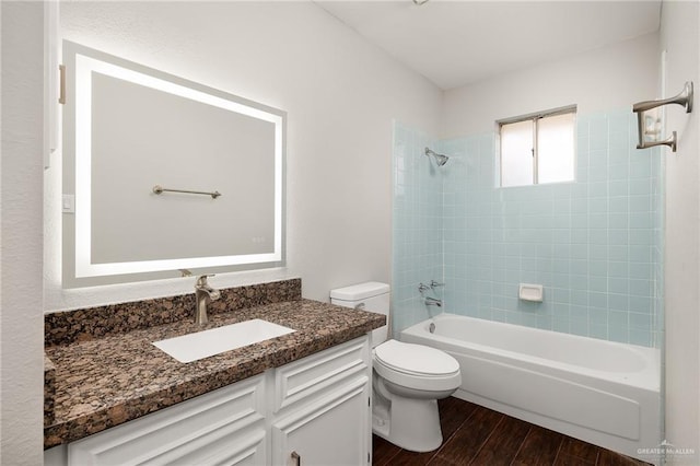 full bath featuring shower / bath combination, vanity, toilet, and wood finished floors