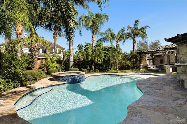 view of pool with a pool with connected hot tub, a patio area, and a pergola