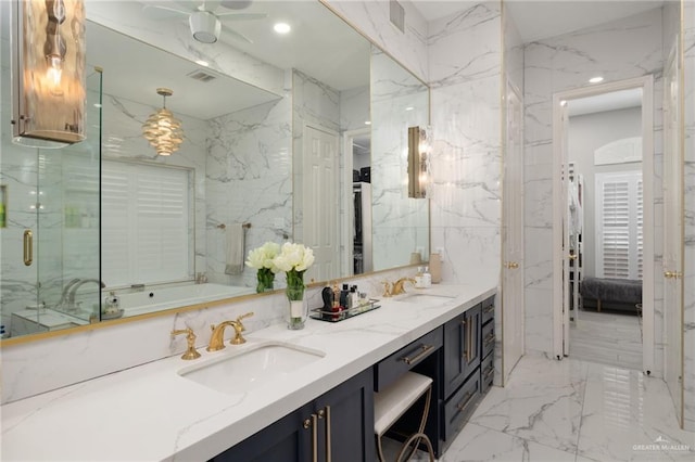 ensuite bathroom with connected bathroom, a sink, and stone wall