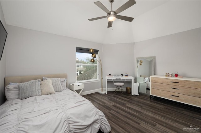 bedroom featuring dark wood-style floors, baseboards, vaulted ceiling, and a ceiling fan