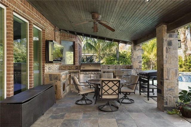 view of patio with outdoor dining space, ceiling fan, and area for grilling