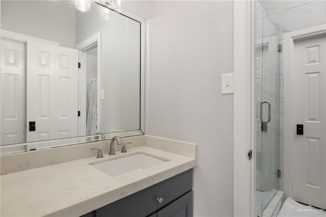 bathroom with a shower stall and vanity