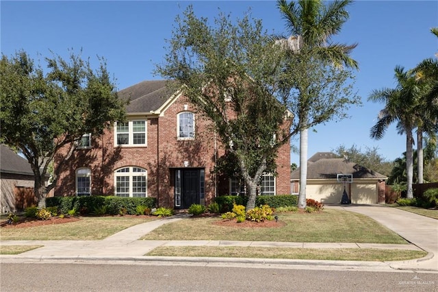 view of front of property featuring a garage, concrete driveway, brick siding, and a front yard