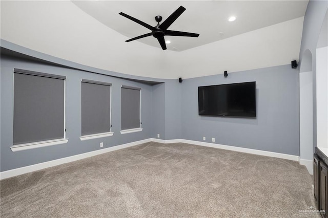 interior space with baseboards, a raised ceiling, ceiling fan, carpet flooring, and recessed lighting