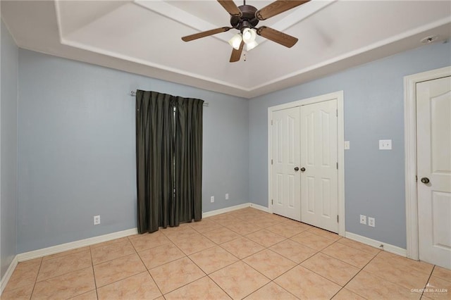 3417 N Pablo St N, Edinburg, TX 78541 - unfurnished bedroom with a ceiling fan, a closet, light tile patterned flooring, a raised ceiling, and baseboards