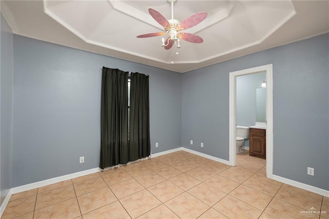 3417 N Pablo St N, Edinburg, TX 78541 - unfurnished room with baseboards, a tray ceiling, ceiling fan, and light tile patterned flooring