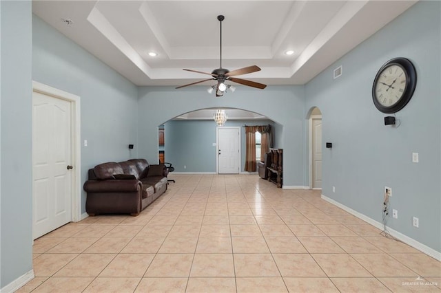 3417 N Pablo St N, Edinburg, TX 78541 - living area with a tray ceiling, arched walkways, visible vents, a ceiling fan, and light tile patterned floors