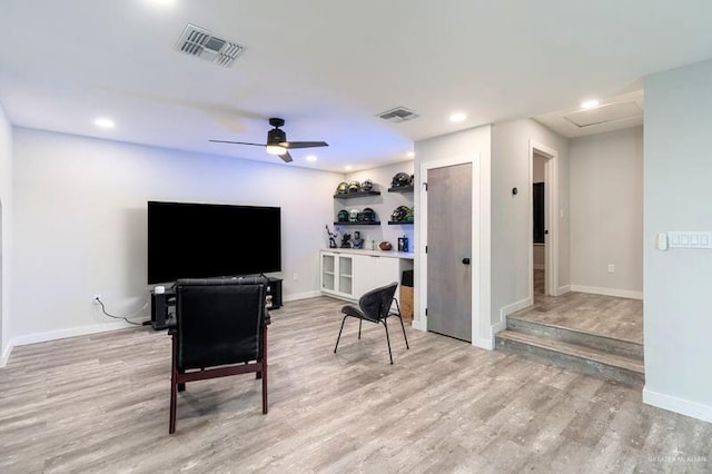 living room featuring light wood-type flooring and ceiling fan