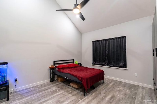 bedroom featuring hardwood / wood-style flooring, high vaulted ceiling, and ceiling fan