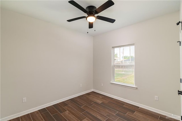 spare room with dark hardwood / wood-style floors and ceiling fan