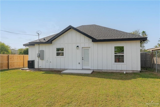 back of house with a yard and cooling unit