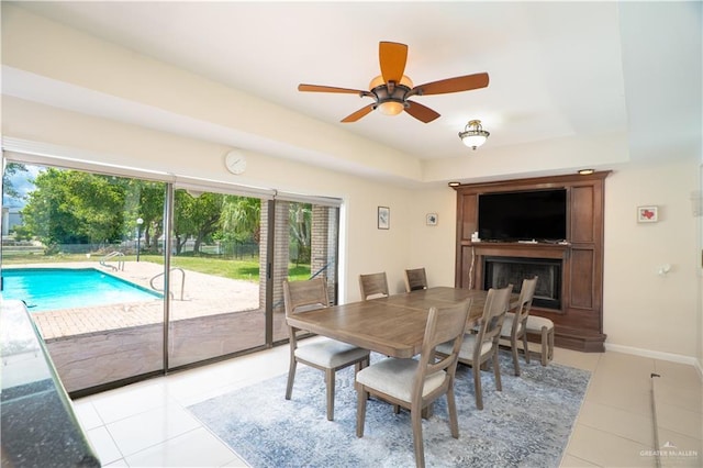 613 Escandon Ave, Rancho Viejo, TX 78575 - dining space featuring a ceiling fan, a tray ceiling, a wealth of natural light, and light tile patterned flooring