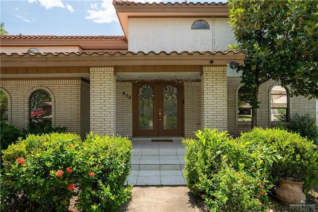 613 Escandon Ave, Rancho Viejo, TX 78575 - entrance to property featuring french doors and brick siding