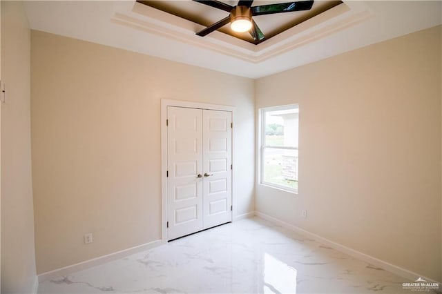 3012 S Livingston St, Edinburg, TX 78542 - unfurnished bedroom featuring a closet, baseboards, marble finish floor, ceiling fan, and a tray ceiling