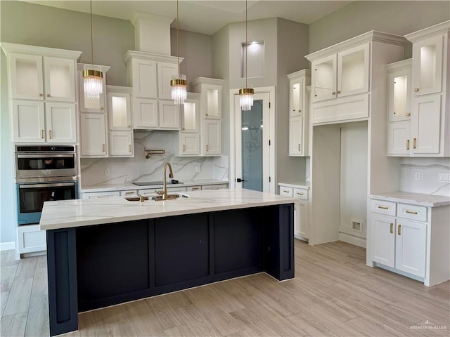 1203 Moses Dr, San Juan, TX 78589 - kitchen with white cabinets, a sink, and double oven