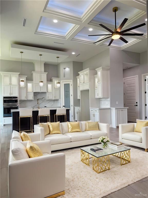 1203 Moses Dr, San Juan, TX 78589 - living room featuring visible vents, light wood finished floors, ceiling fan, recessed lighting, and coffered ceiling