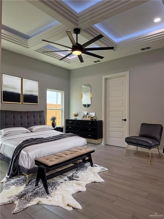 1203 Moses Dr, San Juan, TX 78589 - bedroom featuring coffered ceiling, visible vents, wood finished floors, and ceiling fan