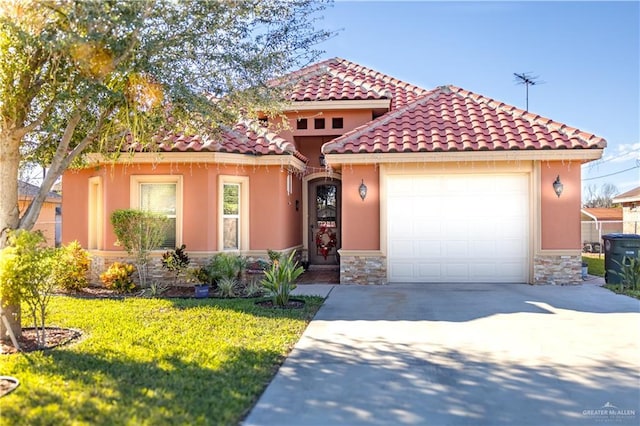 mediterranean / spanish-style home featuring concrete driveway, stone siding, an attached garage, a front yard, and stucco siding