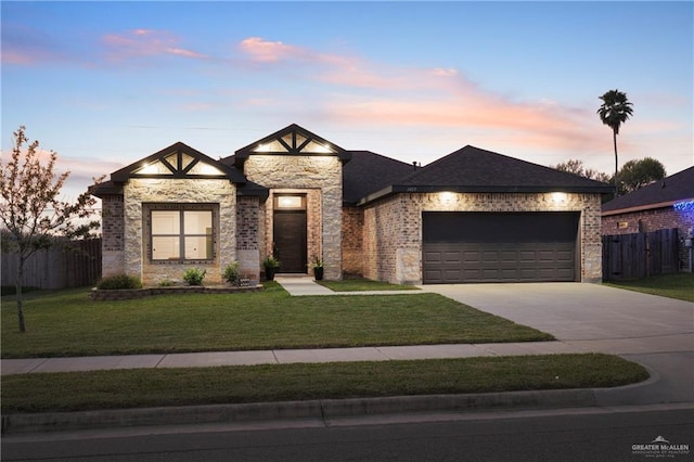 view of front of home with a lawn and a garage