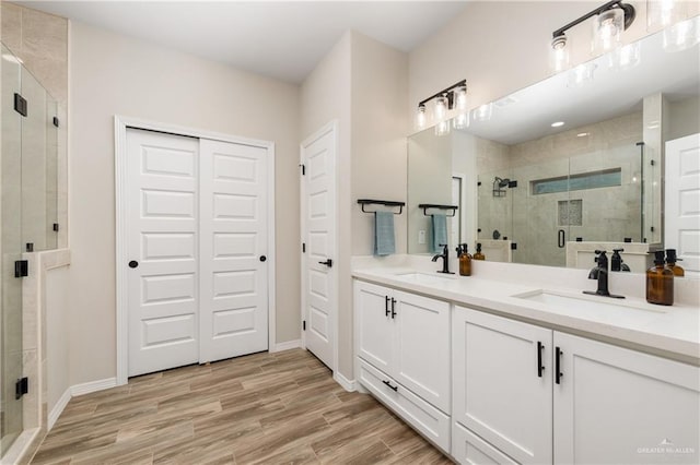 bathroom featuring vanity and a shower with shower door