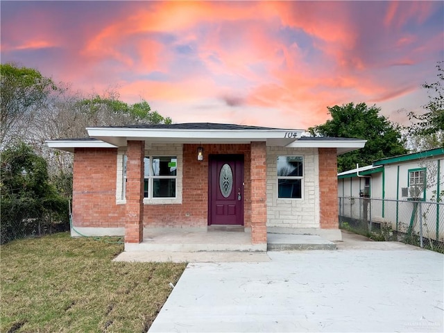 view of front of home with a yard and covered porch