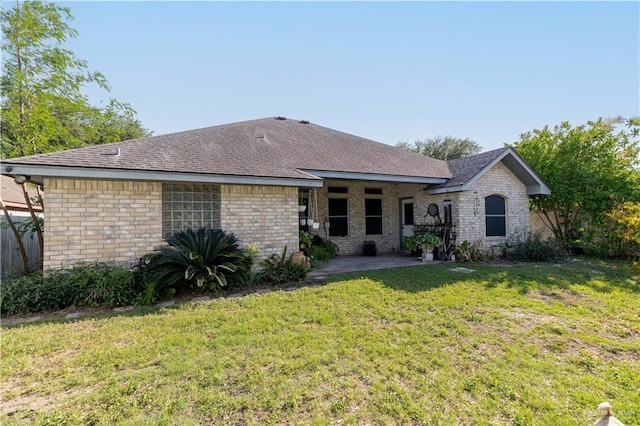 513 E Shasta Ave, Mcallen, TX 78504 - rear view of property featuring a patio, a yard, and brick siding