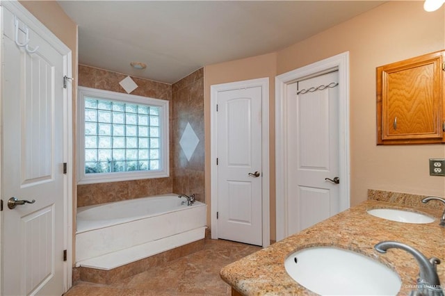 513 E Shasta Ave, Mcallen, TX 78504 - bathroom featuring a garden tub, double vanity, and a closet