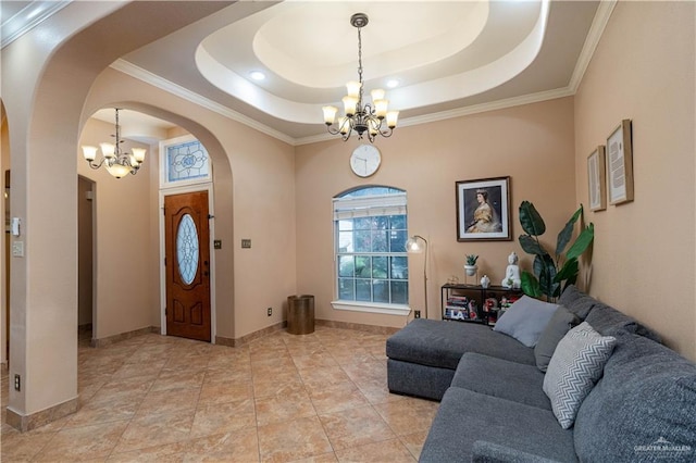 513 E Shasta Ave, Mcallen, TX 78504 - foyer entrance featuring a chandelier, arched walkways, a raised ceiling, and crown molding
