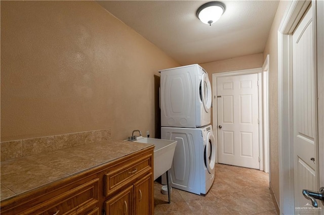 513 E Shasta Ave, Mcallen, TX 78504 - laundry room featuring stacked washer / dryer and cabinet space