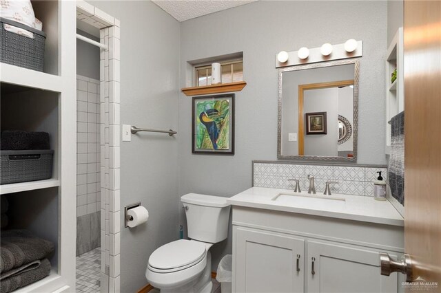 1813 Tyler St, Mission, TX 78572 - bathroom with vanity, tiled shower, and backsplash