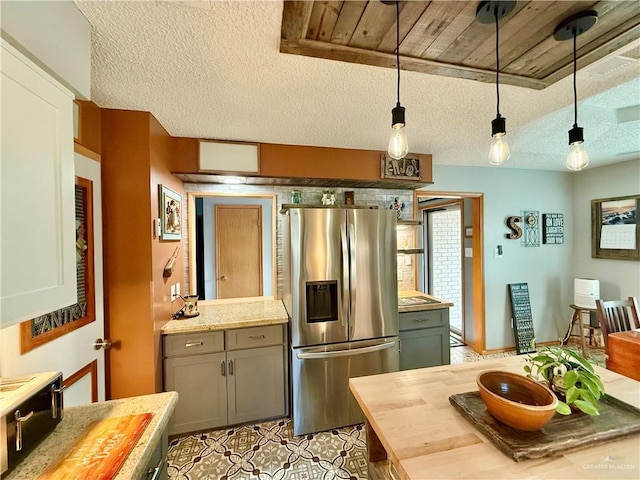1813 Tyler St, Mission, TX 78572 - kitchen featuring stainless steel refrigerator with ice dispenser, wooden counters, a textured ceiling, decorative light fixtures, and gray cabinetry