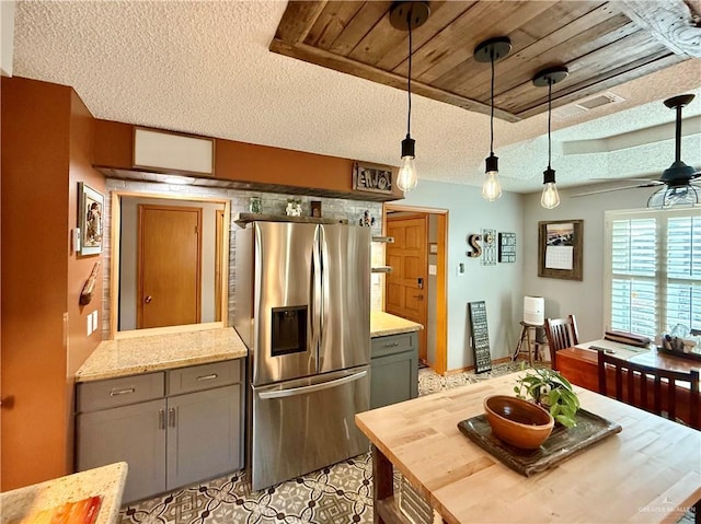 1813 Tyler St, Mission, TX 78572 - kitchen featuring stainless steel fridge with ice dispenser, butcher block counters, gray cabinets, a textured ceiling, and hanging light fixtures