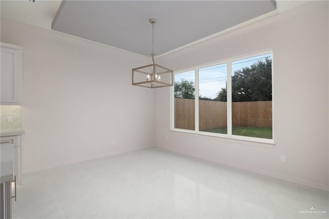 unfurnished dining area with a chandelier