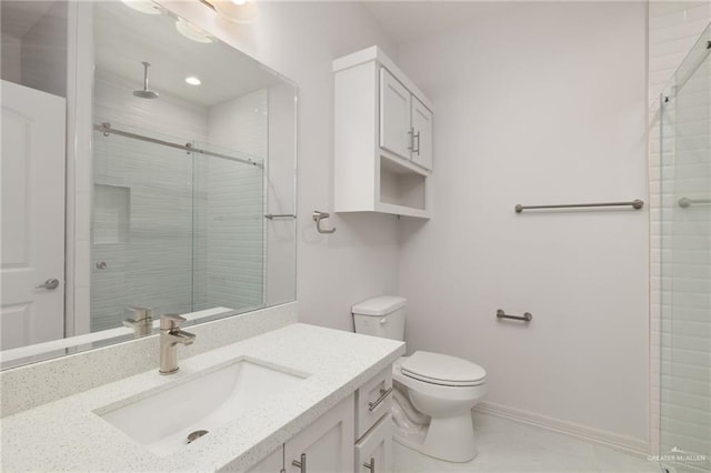 bathroom with vanity, toilet, and a shower with door