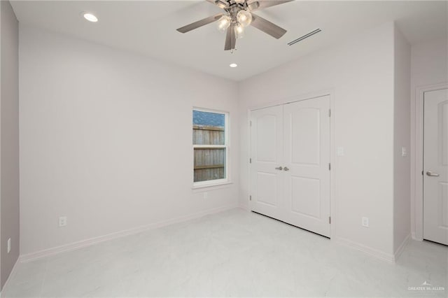 unfurnished bedroom with ceiling fan and a closet