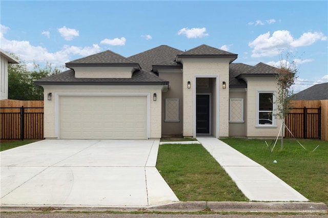 view of front of house featuring a garage and a front yard