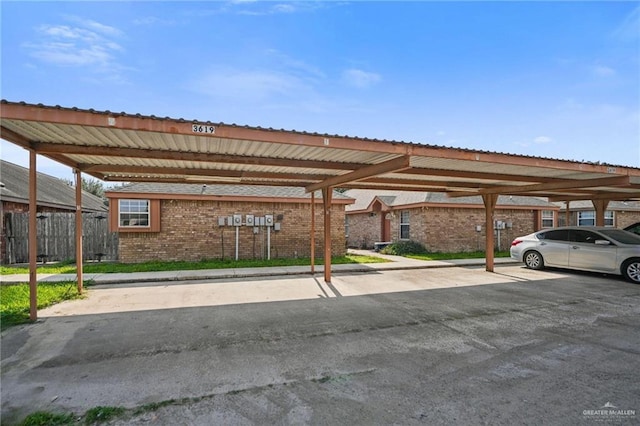 view of parking / parking lot featuring a carport