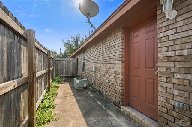 view of property exterior featuring cooling unit and a patio area