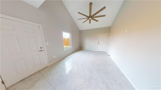 empty room featuring ceiling fan and high vaulted ceiling