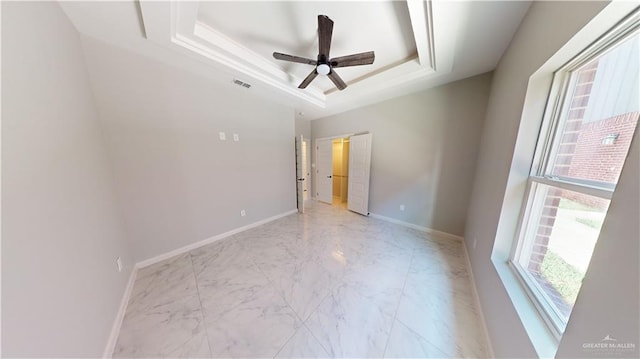 unfurnished bedroom with a raised ceiling and ceiling fan