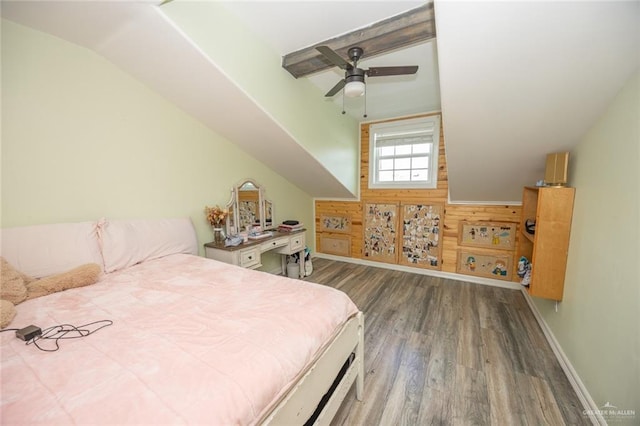 bedroom featuring hardwood / wood-style flooring, ceiling fan, wood walls, and vaulted ceiling