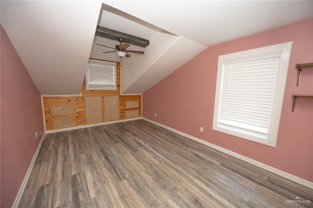 bonus room featuring lofted ceiling with beams, ceiling fan, and wood-type flooring