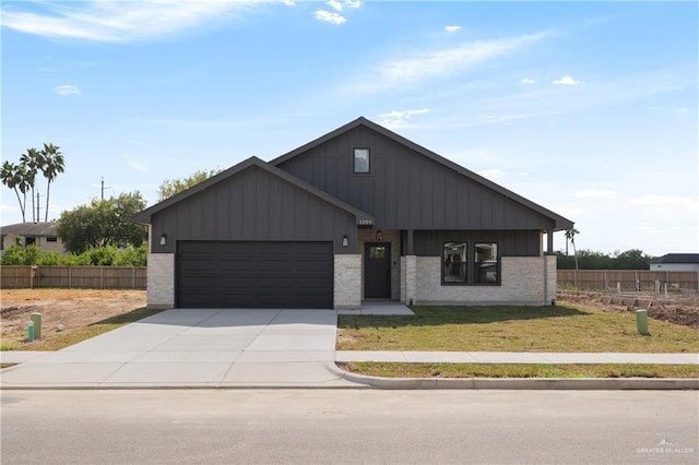 view of front of house featuring a front yard and a garage